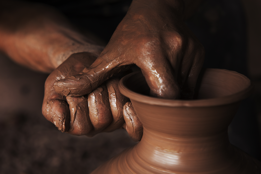 Hands shape clay on a pottery wheel in Rongchang