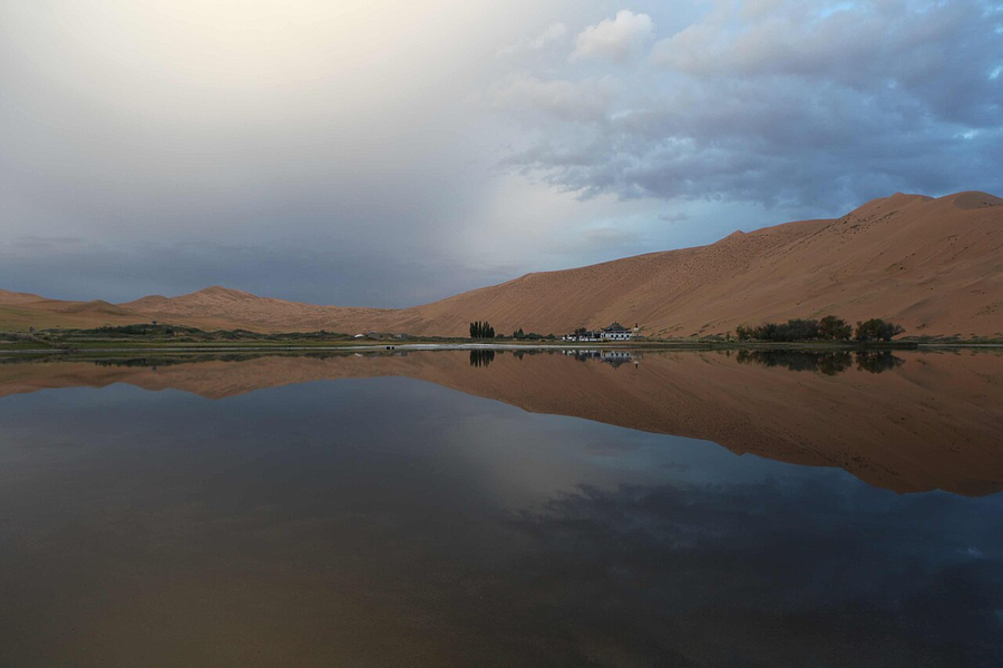 Lake and dunes beside Badain Jaran Temple