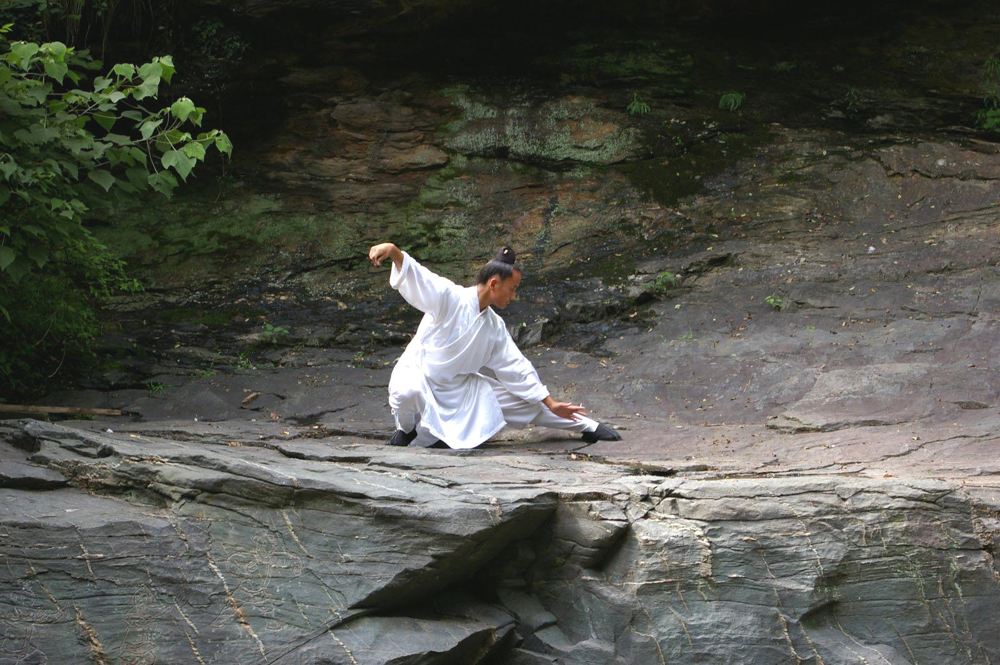 A practitioner of Wudang Taiji in the mountain landscape